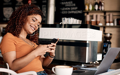 Buy stock photo Shot of a young woman using a cellphone in a cafe