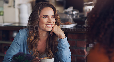 Buy stock photo Shot of a young woman chatting to her friend in a cafe
