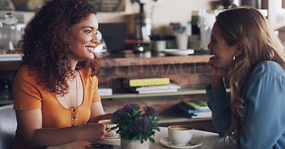 Buy stock photo Shot of two young women chatting in a cafe