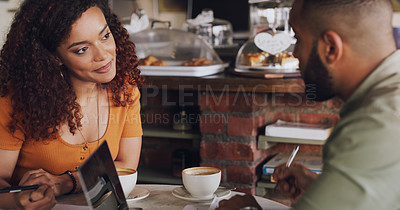 Buy stock photo Shot of a young man and woman having a meeting in a cafe