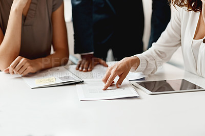 Buy stock photo Shot of an unrecognizable group of businesspeople having a meeting in the office during the day