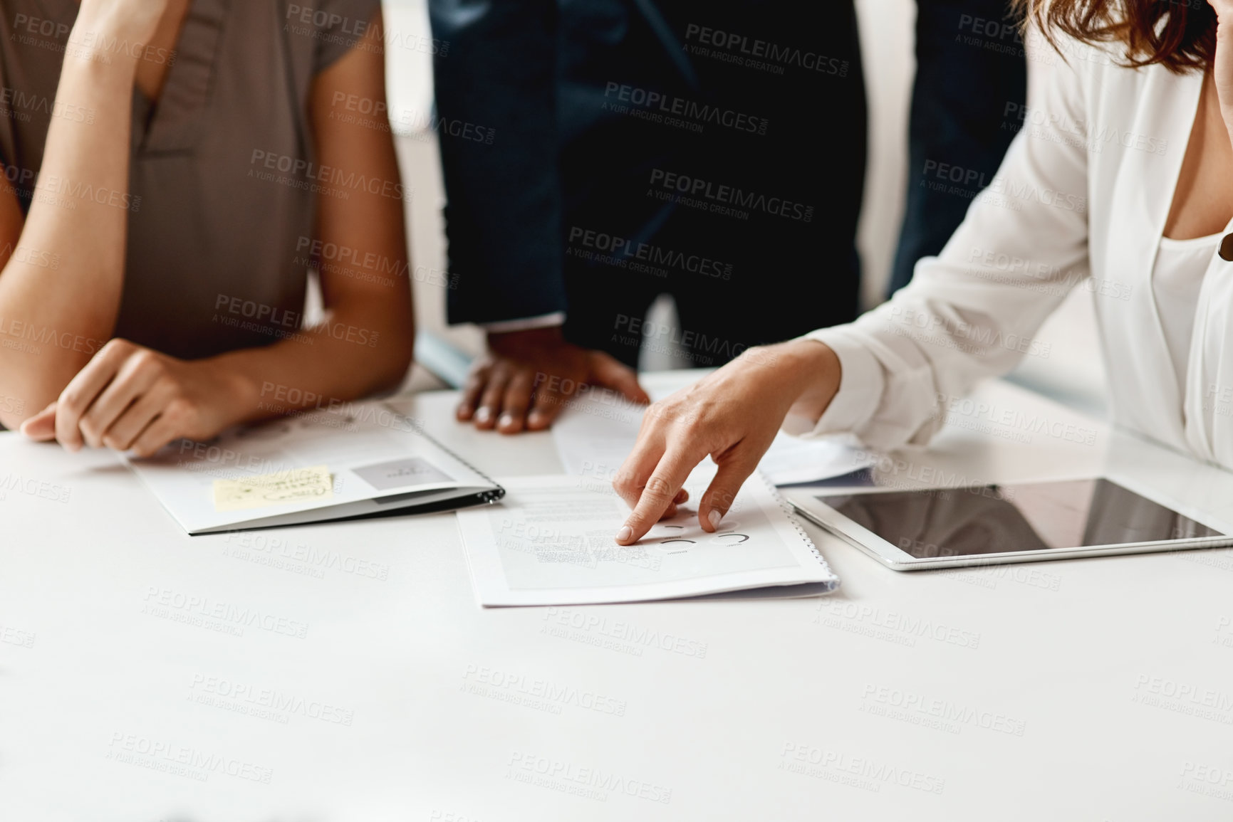 Buy stock photo Shot of an unrecognizable group of businesspeople having a meeting in the office during the day