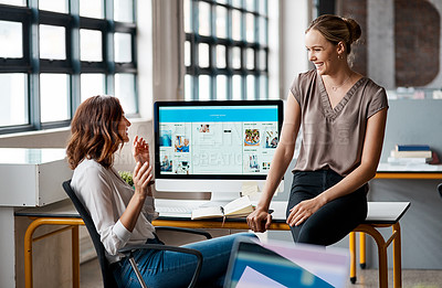 Buy stock photo Shot of two businesswomen having a discussion in an office