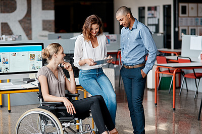 Buy stock photo Shot of a group of businesspeople using a digital tablet together in an office