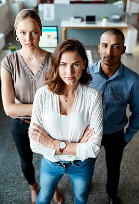 Buy stock photo Shot of a diverse group of businesspeople standing together in the office with their arms folded during the day