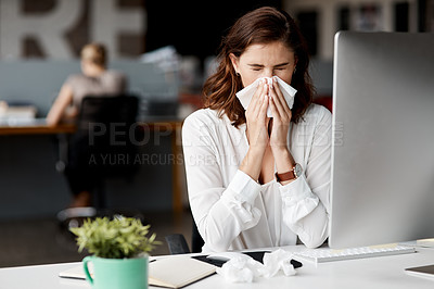 Buy stock photo Shot of an attractive young businesswoman sitting alone at her desk and feeling sick