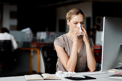 Buy stock photo Shot of an attractive young businesswoman sitting alone at her desk and feeling sick