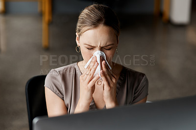 Buy stock photo Shot of an attractive young businesswoman sitting alone at her desk and feeling sick