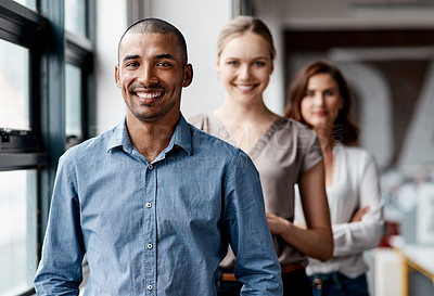 Buy stock photo Shot of a diverse group of businesspeople standing in a line behind each other in the office during the day