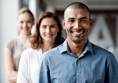 Buy stock photo Shot of a diverse group of businesspeople standing in a line behind each other in the office during the day