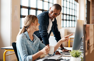 Buy stock photo Shot of two businesspeople working together on a computer in an office