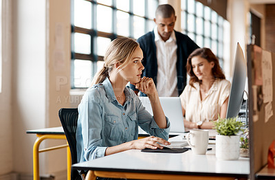 Buy stock photo Shot of a young businesswoman working on a computer in an office