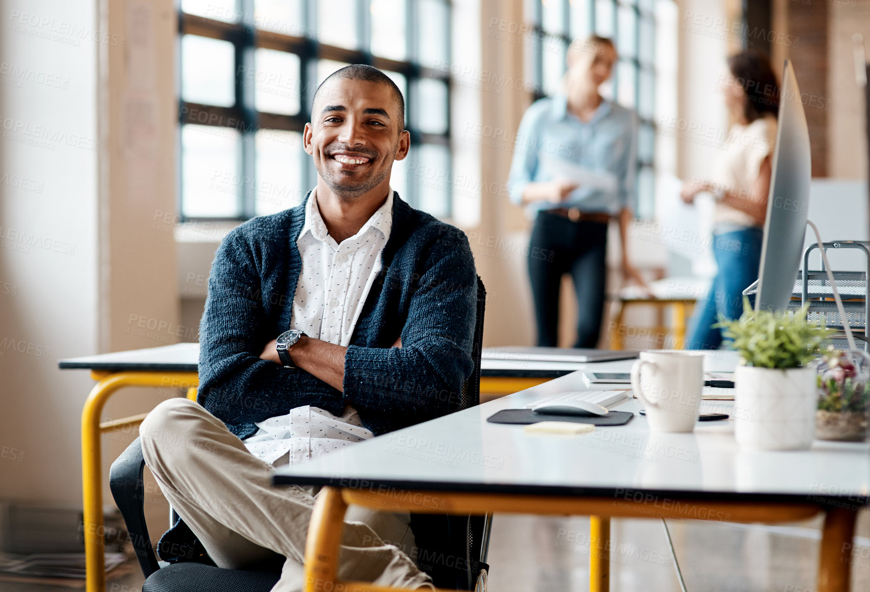 Buy stock photo Portrait of a confident young businessman working in an office