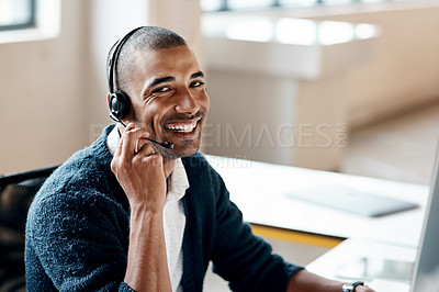 Buy stock photo Portrait of a young businessman wearing a headset while working in an office