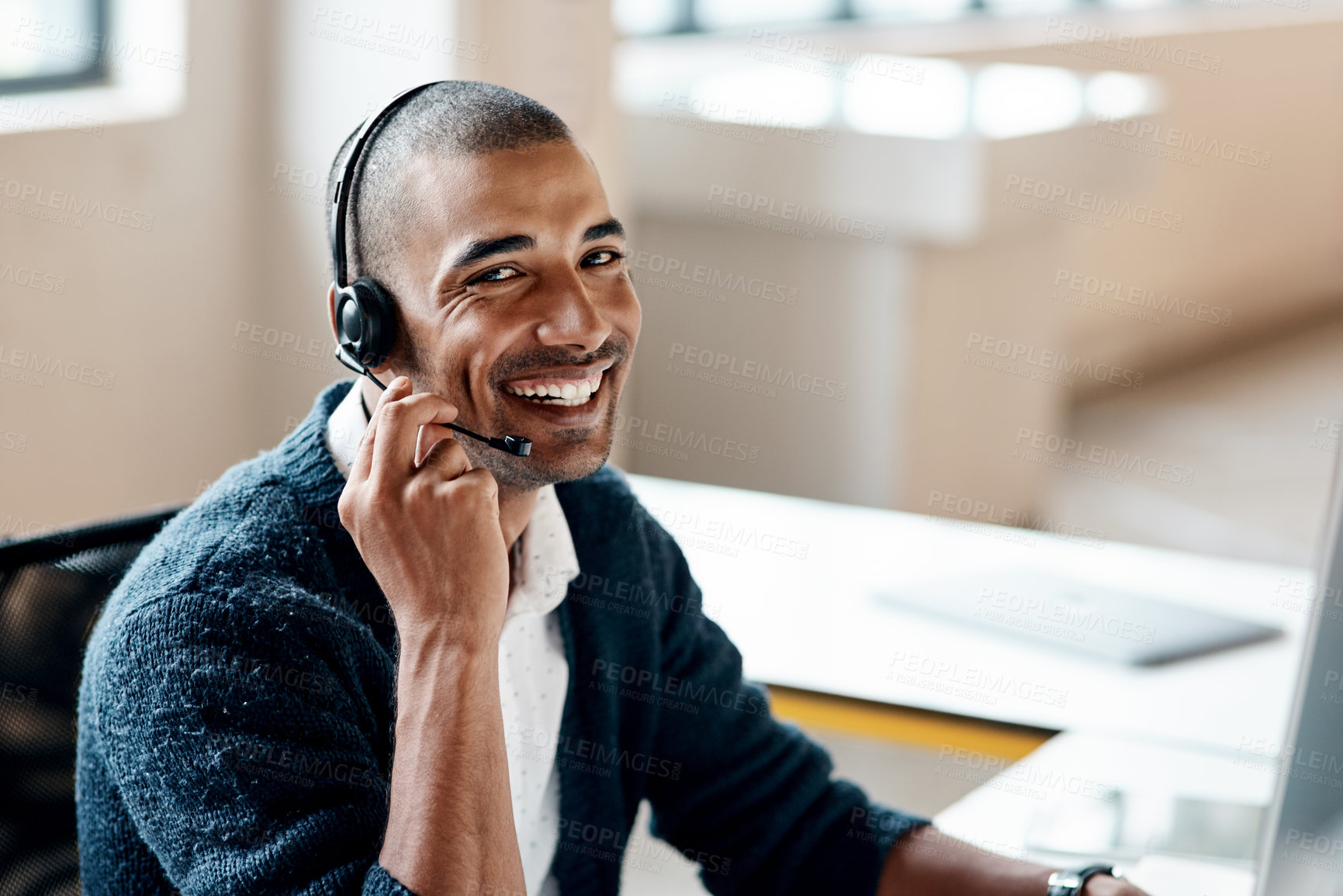 Buy stock photo Portrait of a young businessman wearing a headset while working in an office