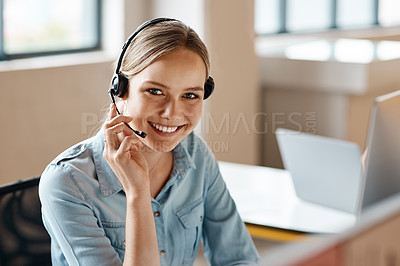 Buy stock photo Portrait of a young businesswoman wearing a headset while working in an office
