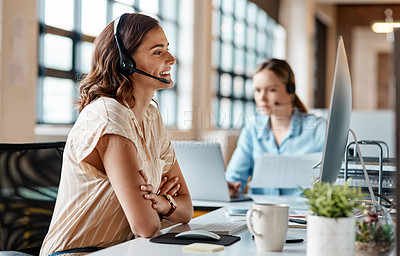 Buy stock photo Shot of a young businesswoman wearing a headset while working on a computer in an office