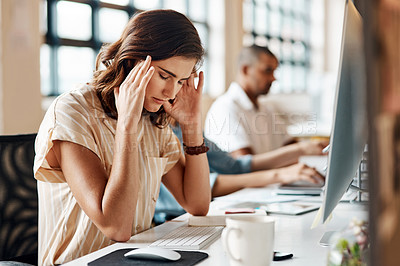 Buy stock photo Shot of a young businesswoman looking stressed out while working in an office