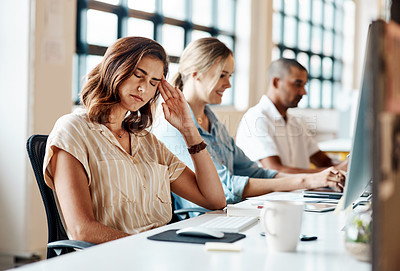 Buy stock photo Shot of a young businesswoman looking stressed out while working in an office