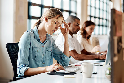 Buy stock photo Shot of a young businesswoman looking stressed out while working in an office