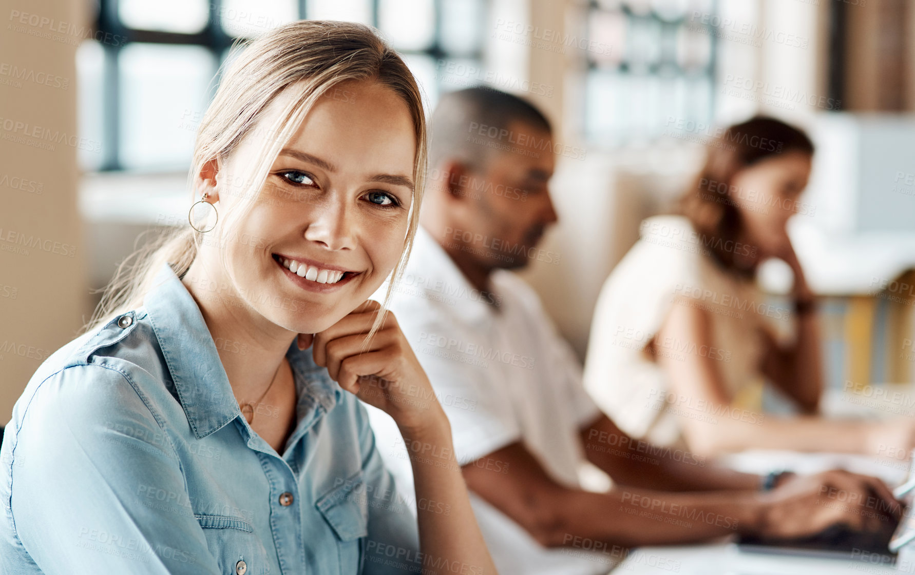 Buy stock photo Portrait of a young businesswoman working on a computer in an office