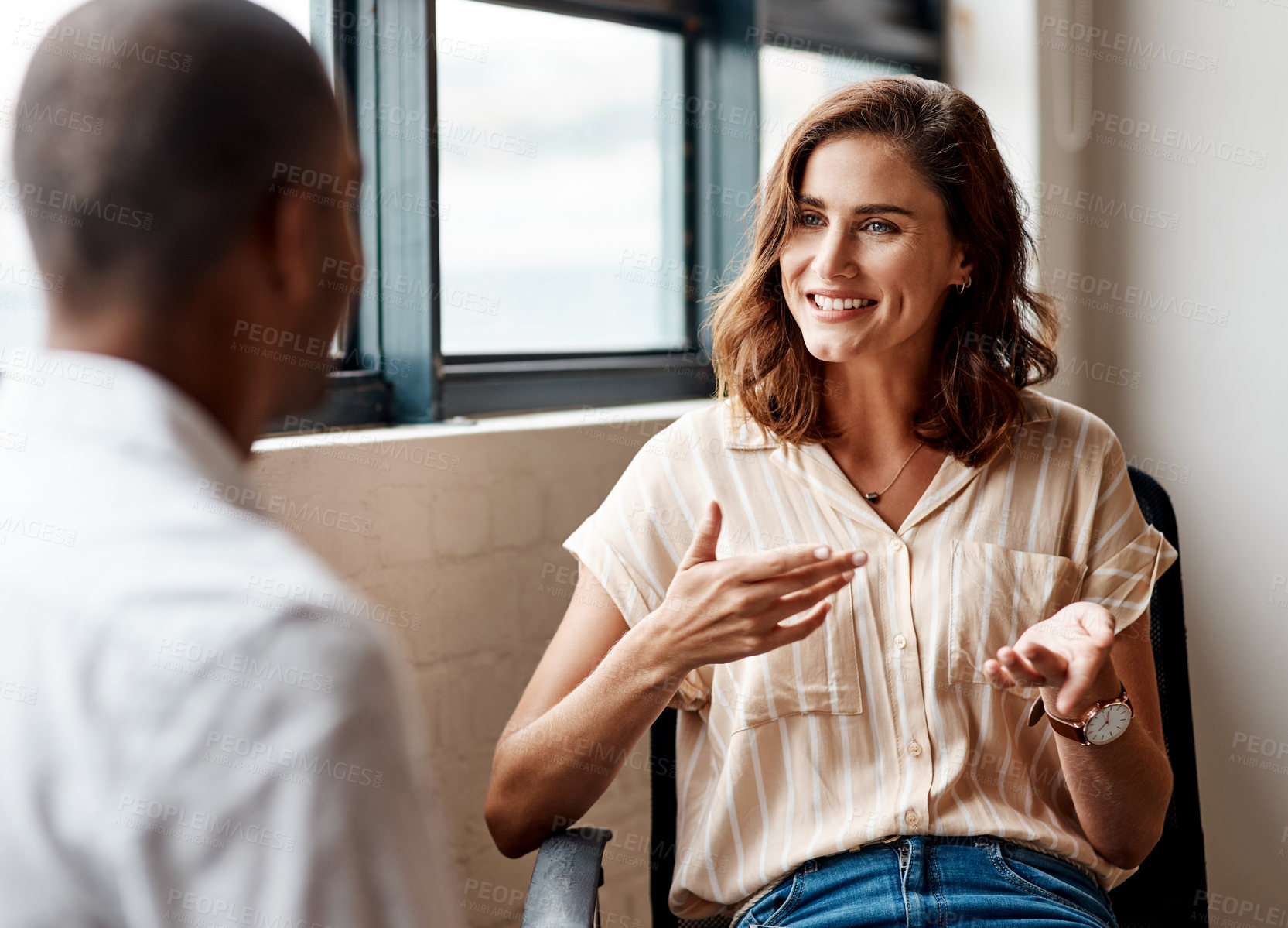 Buy stock photo Shot of a young businesswoman having a discussion with a colleague in an office