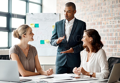 Buy stock photo Shot of a group of businesspeople having a meeting in an office