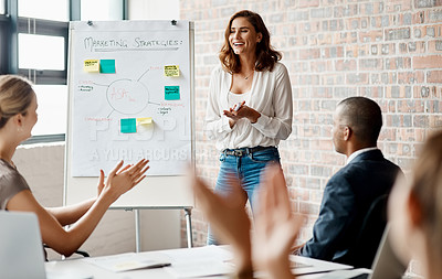 Buy stock photo Shot of a young businesswoman receiving applause during a presentation in an office