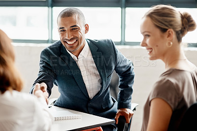 Buy stock photo Shot of businesspeople shaking hands in an office