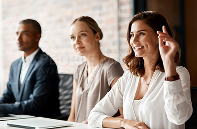 Buy stock photo Shot of a young businesswoman raising her hand during a meeting in an office