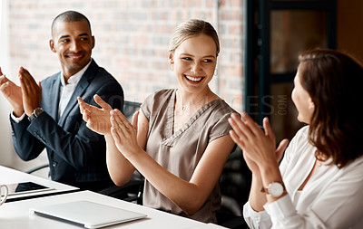 Buy stock photo Shot of a group of businesspeople applauding during a meeting in an office