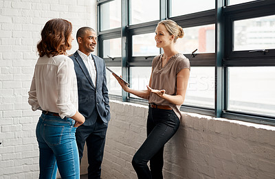 Buy stock photo Shot of a group of businesspeople having a discussion in an office