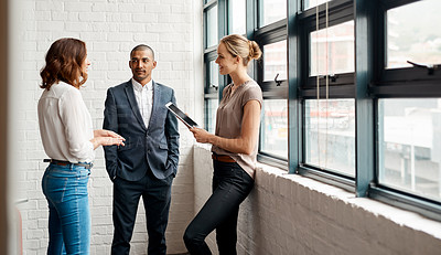 Buy stock photo Shot of a group of businesspeople having a discussion in an office