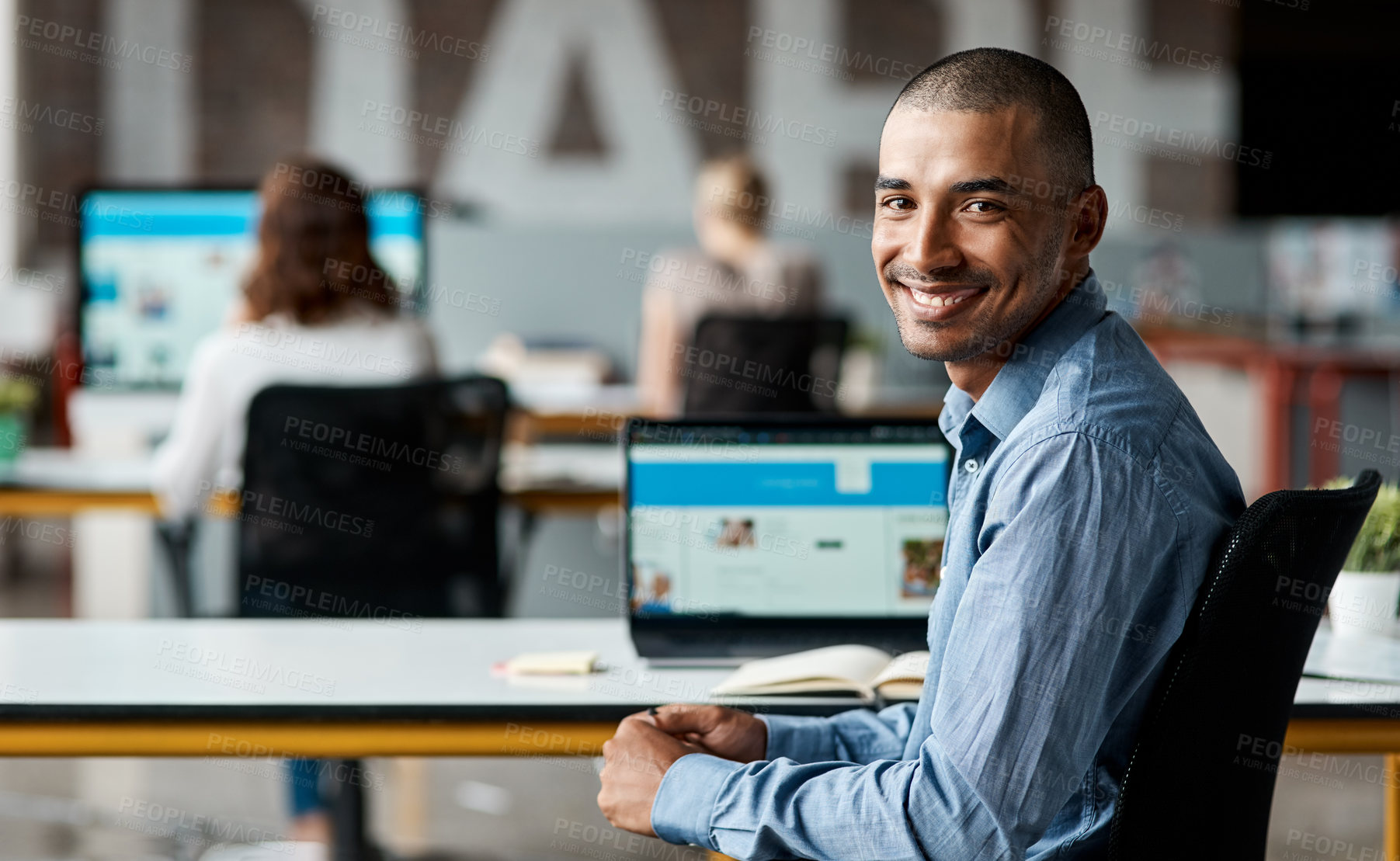 Buy stock photo Portrait of a confident young businessman working in an office