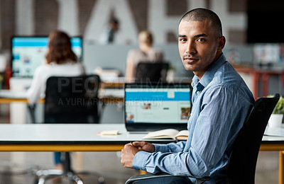 Buy stock photo Portrait of a confident young businessman working in an office