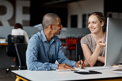 Buy stock photo Shot of two businesspeople working together on a computer in an office