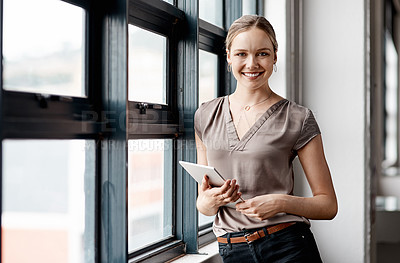 Buy stock photo Portrait of a young businesswoman using a digital tablet in an office
