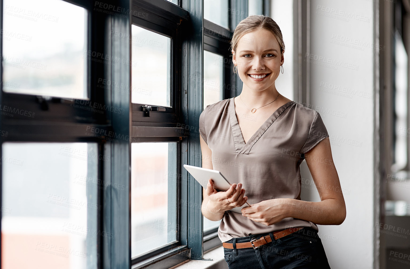 Buy stock photo Portrait of a young businesswoman using a digital tablet in an office