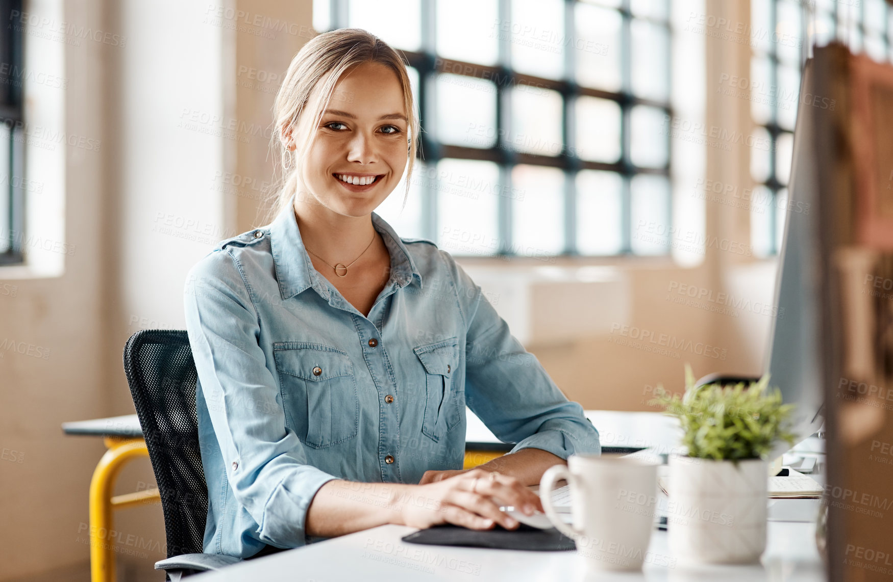 Buy stock photo Portrait of a young businesswoman using a computer in a modern office