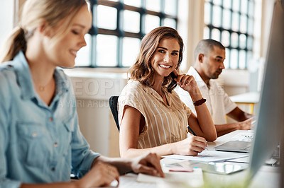 Buy stock photo Shot of a young businesswoman using a computer in a modern office