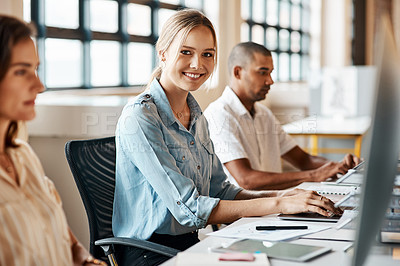 Buy stock photo Shot of a young businesswoman using a computer in a modern office