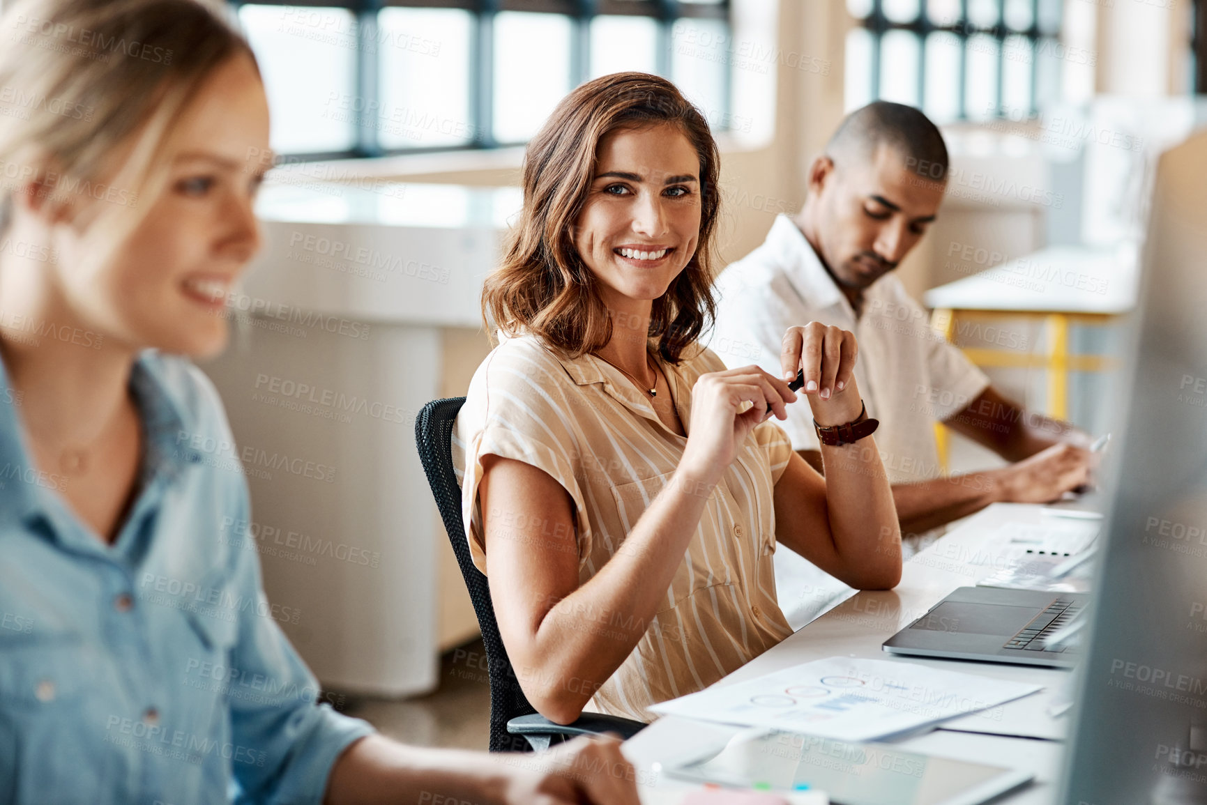 Buy stock photo Shot of a young businesswoman using a computer in a modern office