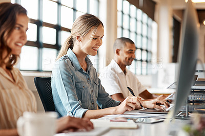 Buy stock photo Shot of a young businesswoman using a computer in a modern office