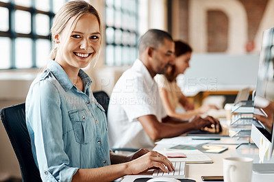 Buy stock photo Shot of a young businesswoman using a computer in a modern office