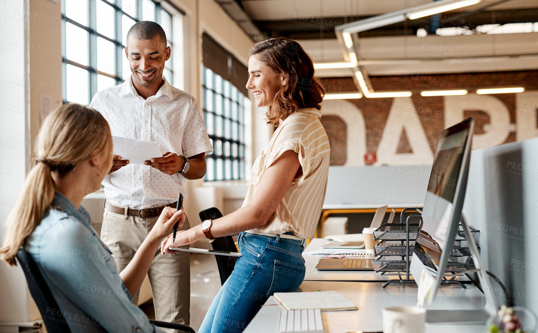 Buy stock photo Shot of a group of young businesspeople having a meeting in a modern office