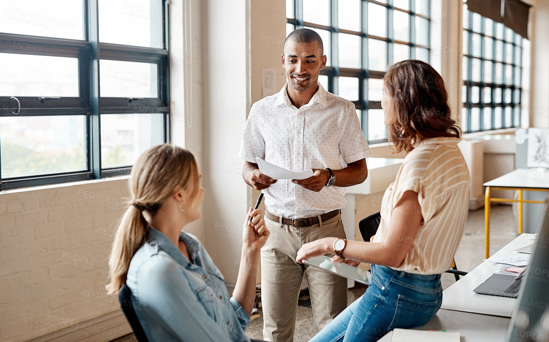 Buy stock photo Shot of a group of young businesspeople having a meeting in a modern office