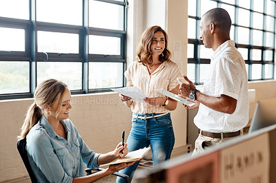 Buy stock photo Shot of a group of young businesspeople having a meeting in a modern office