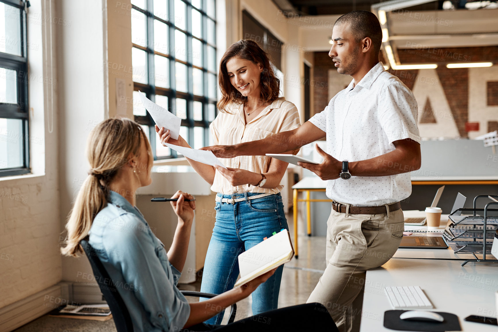 Buy stock photo Shot of a group of young businesspeople having a meeting in a modern office