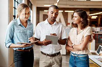 Buy stock photo Shot of a group of young businesspeople having a meeting in a modern office