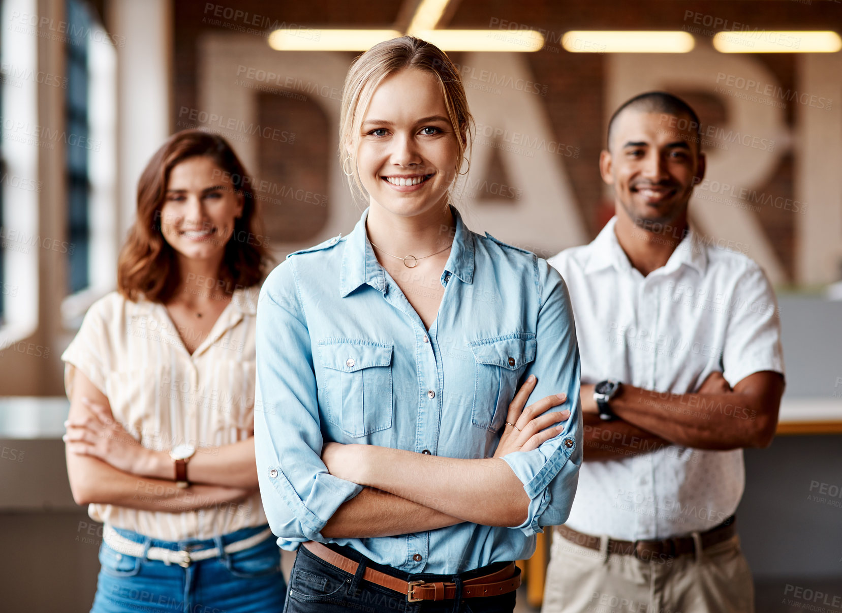Buy stock photo Portrait of a group of confident young businesspeople working together in a modern office